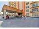 Condo building entrance with covered parking and landscaped area at 4900 Brittany S Dr # 701, St Petersburg, FL 33715