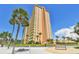 Luxury high-rise building with palm trees and a seating area at 4900 Brittany S Dr # 701, St Petersburg, FL 33715