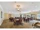 Elegant community room with tables, chairs, and a chandelier at 4900 Brittany S Dr # 701, St Petersburg, FL 33715