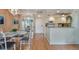 Dining area with glass table, chairs, and kitchen access at 4900 Brittany S Dr # 701, St Petersburg, FL 33715