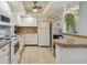 Kitchen with white cabinets, granite countertops, and white appliances at 4900 Brittany S Dr # 701, St Petersburg, FL 33715