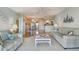 Living room with striped couches, coffee table, and view of bedroom at 4900 Brittany S Dr # 701, St Petersburg, FL 33715