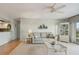 Bright living room with comfy sofa, coffee table, and access to a balcony at 4900 Brittany S Dr # 701, St Petersburg, FL 33715