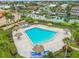 Inviting community pool surrounded by tropical landscaping at 4900 Brittany S Dr # 701, St Petersburg, FL 33715
