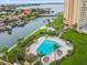 Relaxing triangular pool with lounge chairs and palm trees at 4900 Brittany S Dr # 701, St Petersburg, FL 33715