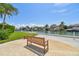 Relaxing waterfront view with a wooden bench and lush greenery at 4900 Brittany S Dr # 701, St Petersburg, FL 33715