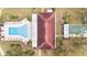 Community pool, shuffleboard, and clubhouse are shown in this aerial view at 4920 Locust Ne St # 116, St Petersburg, FL 33703