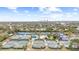 Aerial view showing multiple tennis courts and a distant cityscape at 4920 Locust Ne St # 116, St Petersburg, FL 33703