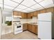 Cozy kitchen with wood cabinets and white appliances at 4920 Locust Ne St # 116, St Petersburg, FL 33703