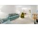Comfortable living room featuring a teal sofa and green armchair at 4920 Locust Ne St # 116, St Petersburg, FL 33703