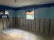 Unfinished basement with blue walls and window at 4933 Venetian Ne Blvd, St Petersburg, FL 33703