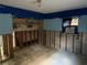 Unfinished basement with shelving and damaged walls at 4933 Venetian Ne Blvd, St Petersburg, FL 33703