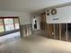 Living room under renovation with view into kitchen at 4933 Venetian Ne Blvd, St Petersburg, FL 33703
