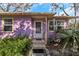 Charming purple house with a white door and landscaped yard at 5309 21St S Ave, Gulfport, FL 33707
