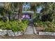 Purple house with lush tropical landscaping at 5309 21St S Ave, Gulfport, FL 33707