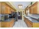 Kitchen with stainless steel appliances and wood cabinets at 5309 21St S Ave, Gulfport, FL 33707