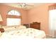 Two twin beds, dresser, and arched window at 5581 Salem Square S Dr, Palm Harbor, FL 34685