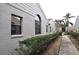 Neat walkway and manicured hedges along the home's side at 5581 Salem Square S Dr, Palm Harbor, FL 34685