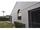 Side view showcasing home's exterior and landscaping at 5581 Salem Square S Dr, Palm Harbor, FL 34685