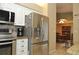 Modern kitchen featuring stainless steel refrigerator and granite countertops at 5581 Salem Square S Dr, Palm Harbor, FL 34685