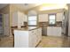 Kitchen with white cabinets, granite counters, and stainless steel appliances at 5581 Salem Square S Dr, Palm Harbor, FL 34685