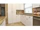 White kitchen cabinets and granite countertops at 5581 Salem Square S Dr, Palm Harbor, FL 34685