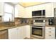 Bright kitchen with stainless steel appliances and granite countertops at 5581 Salem Square S Dr, Palm Harbor, FL 34685