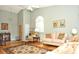 Living room with hardwood floors, comfortable seating, and large windows at 5581 Salem Square S Dr, Palm Harbor, FL 34685