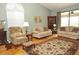 Spacious living room with hardwood floors, light walls and comfy furniture at 5581 Salem Square S Dr, Palm Harbor, FL 34685