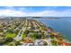 Aerial view of waterfront homes with lush landscaping and a beautiful shoreline at 608 Columbus Dr, Tierra Verde, FL 33715