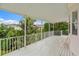 White-railed balcony with leafy, tropical views at 608 Columbus Dr, Tierra Verde, FL 33715
