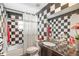 Bathroom with black and white checkered tile and granite vanity at 608 Columbus Dr, Tierra Verde, FL 33715