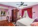 Bedroom with purple walls, hardwood floors, and a large bed at 608 Columbus Dr, Tierra Verde, FL 33715
