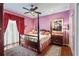 Bedroom with purple walls, hardwood floors, and a large bed at 608 Columbus Dr, Tierra Verde, FL 33715