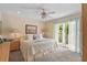 Bright bedroom with king-size bed and access to balcony at 608 Columbus Dr, Tierra Verde, FL 33715