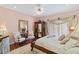 Elegant bedroom with hardwood floors, a large bed, and ample natural light at 608 Columbus Dr, Tierra Verde, FL 33715