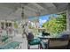 Covered deck with seating, glass-top table, and waterfront view at 608 Columbus Dr, Tierra Verde, FL 33715