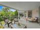 Covered deck with comfy seating and lovely backyard view at 608 Columbus Dr, Tierra Verde, FL 33715