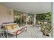 Covered deck with daybed, seating, and views of the home's interior at 608 Columbus Dr, Tierra Verde, FL 33715