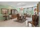 Bright dining room featuring a wood table and chairs, elegant chandelier, and built-in hutch at 608 Columbus Dr, Tierra Verde, FL 33715