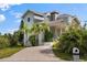 Two-story home with brick driveway and lush landscaping at 608 Columbus Dr, Tierra Verde, FL 33715