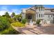 Impressive home with a circular driveway and lush landscaping at 608 Columbus Dr, Tierra Verde, FL 33715