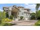 Beautiful waterfront home with a grand entrance and lush landscaping at 608 Columbus Dr, Tierra Verde, FL 33715