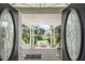 View from entryway showcasing landscaped front yard at 608 Columbus Dr, Tierra Verde, FL 33715