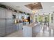 Bright kitchen featuring light gray cabinets, granite countertops, and stainless steel appliances at 608 Columbus Dr, Tierra Verde, FL 33715