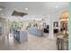 Open floor plan showcasing a large kitchen island and living area with tile flooring at 608 Columbus Dr, Tierra Verde, FL 33715
