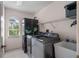 Convenient laundry room with washer, dryer, and storage at 608 Columbus Dr, Tierra Verde, FL 33715