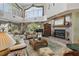 Living room featuring a fireplace and large windows at 608 Columbus Dr, Tierra Verde, FL 33715