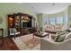 Elegant living room with a large TV, comfortable seating, and hardwood floors at 608 Columbus Dr, Tierra Verde, FL 33715