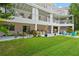 Ground level patio with multiple seating areas and lush landscaping at 608 Columbus Dr, Tierra Verde, FL 33715